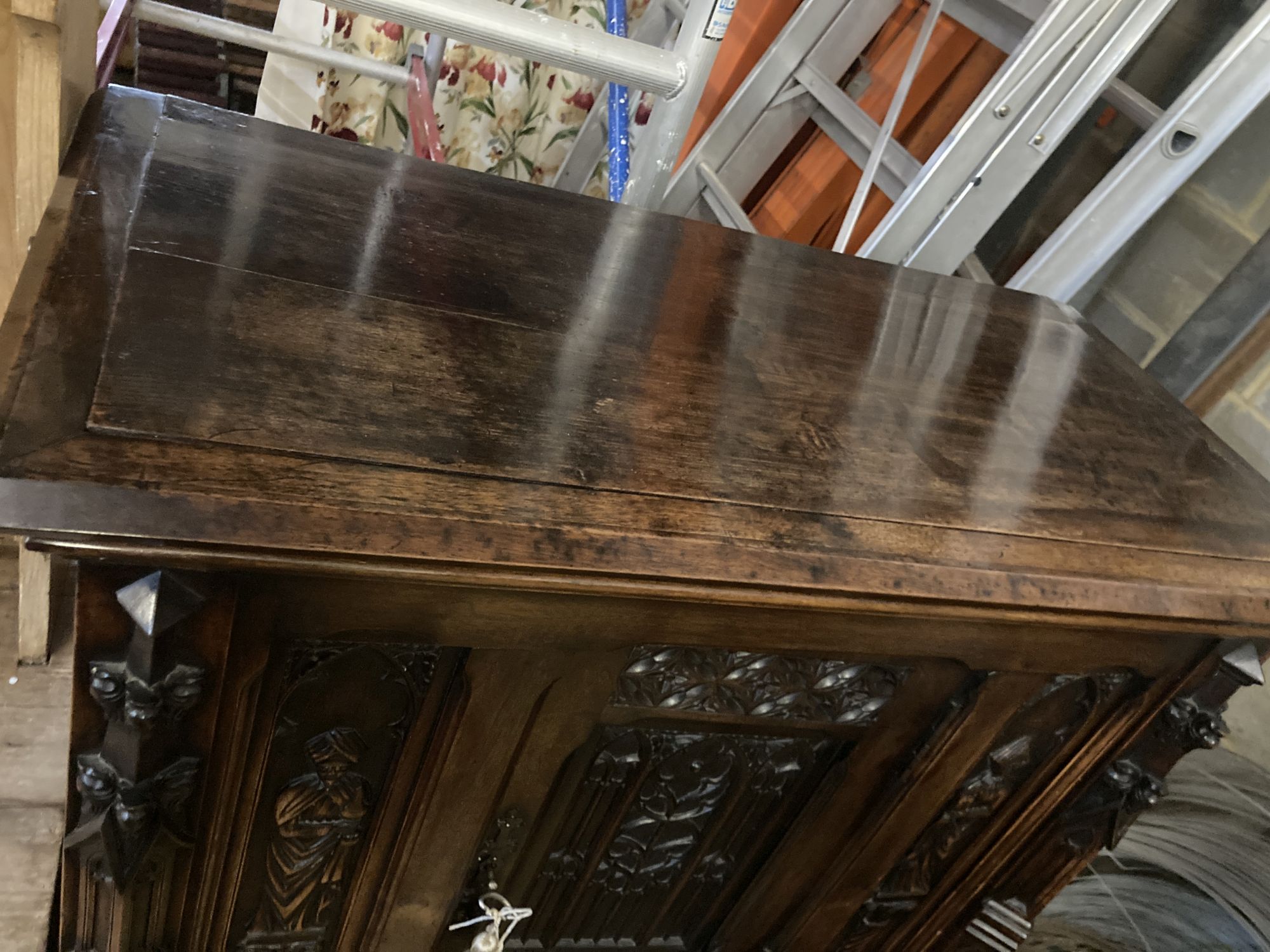 A medieval style carved walnut side cabinet, width 90cm, depth 44cm, height 140cm